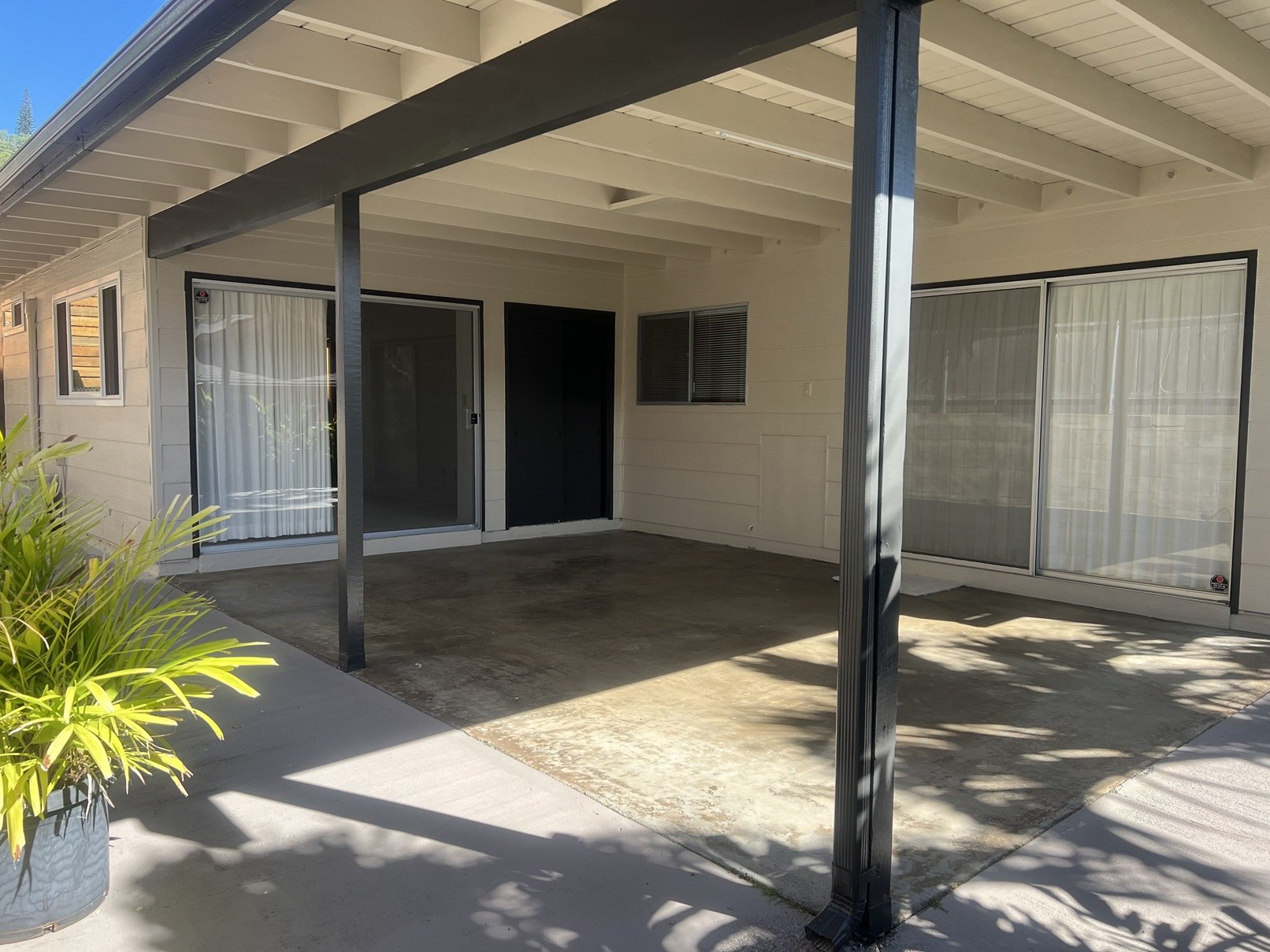 A house with a covered patio and a door.